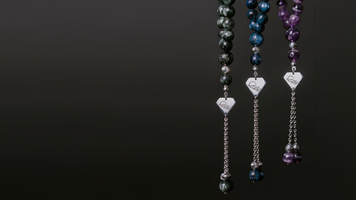 Three Anakaty masbaha in natural stone, each with an engraved silver tag